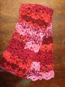 Reds, purples and pink swirl together in this scarf.